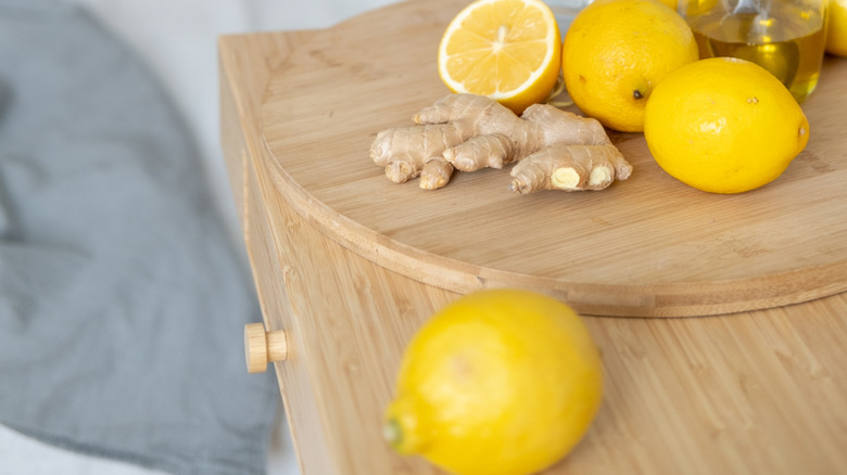 woman in bed near table of lemons