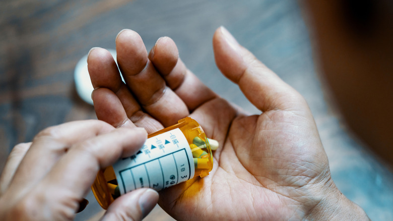 man's hand holding medication