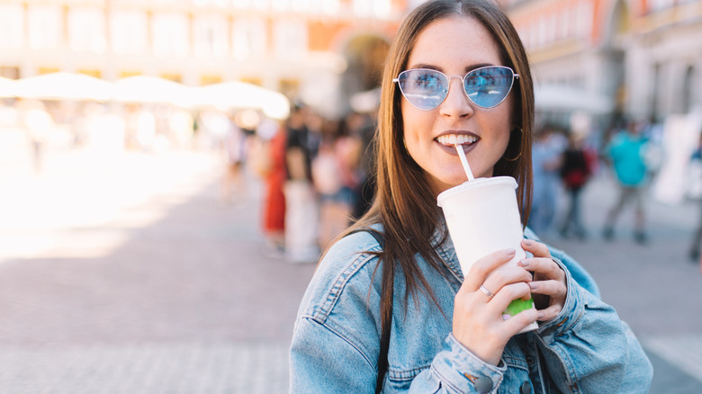 woman drinking from cup