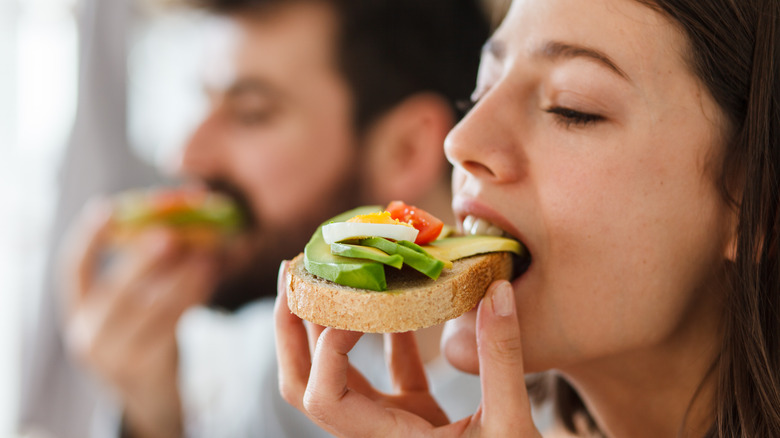 Woman eating avocado toast