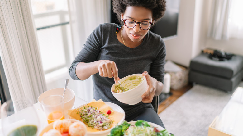 Woman making avocado salad