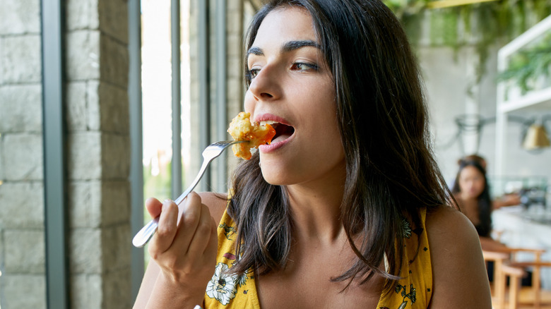 Woman eating fried cauliflower