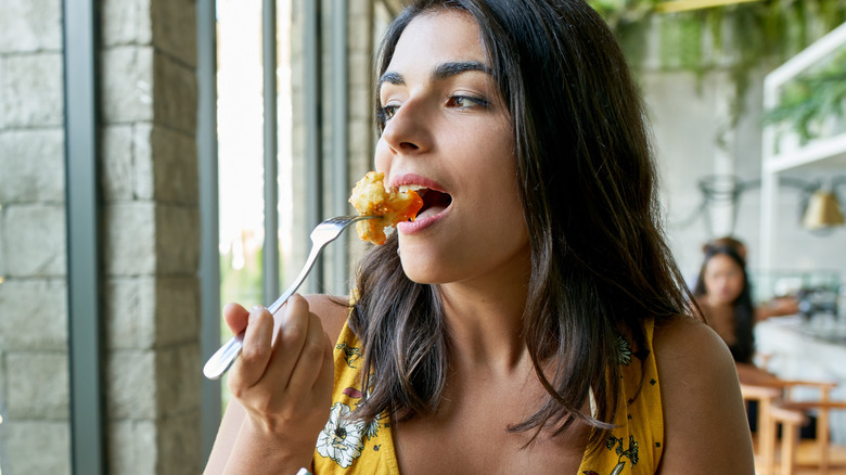 Woman eating fried cauliflower