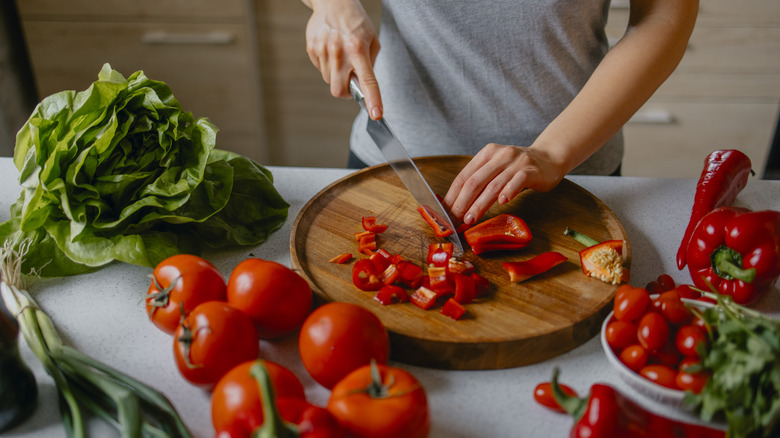 Woman slicing into peppers