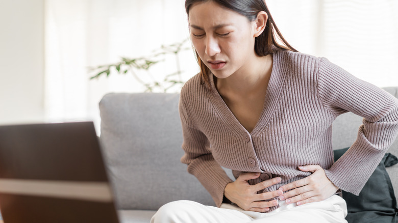 Woman holding abdomen