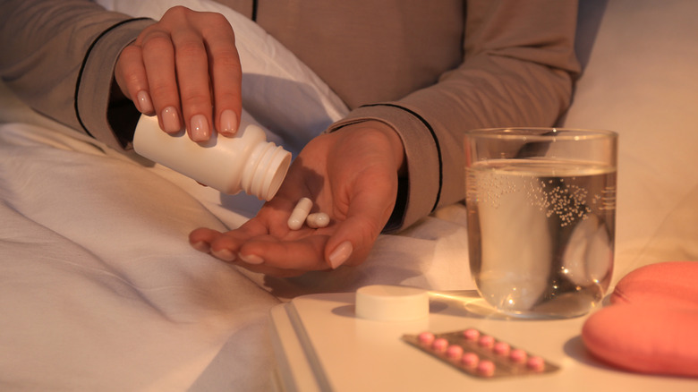 pouring pills while in bed