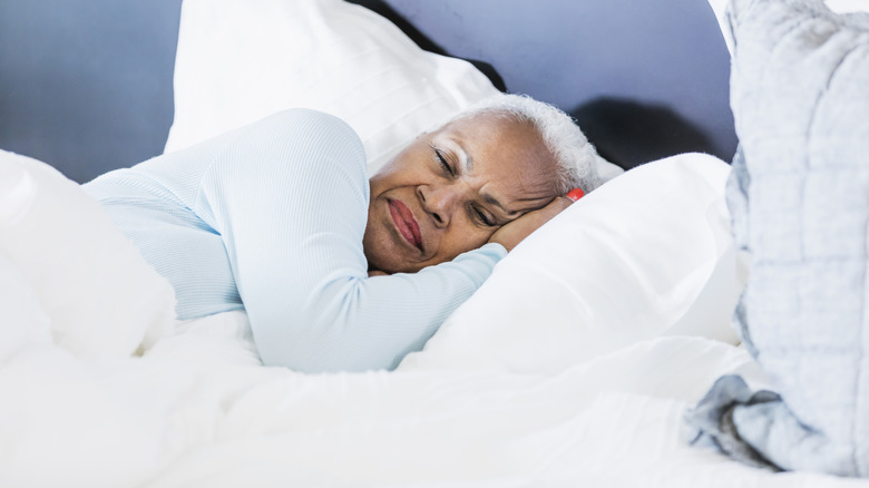 Older woman sleeping on side