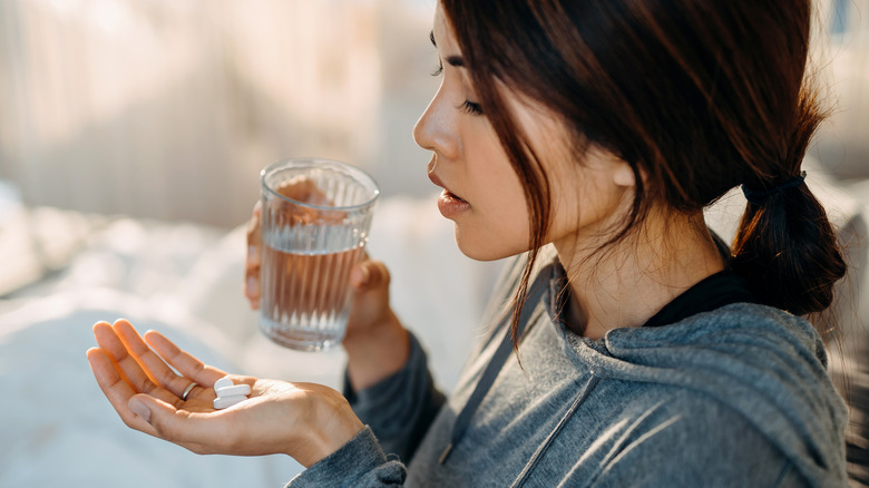 woman about to take medication