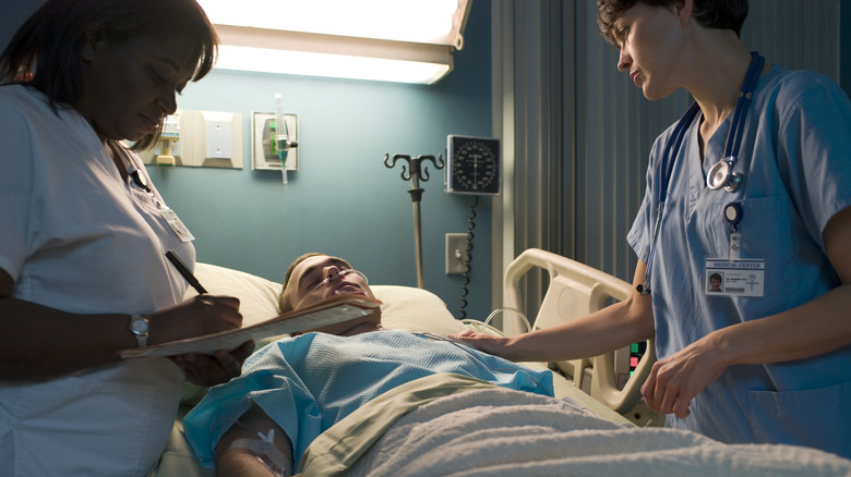 Hospitalized patient talking to healthcare professionals