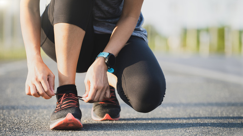 Person tying running shoes