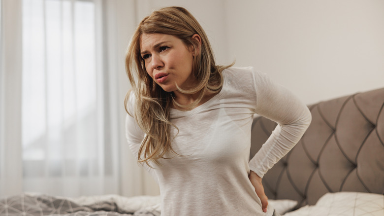 Woman holding lower back in pain