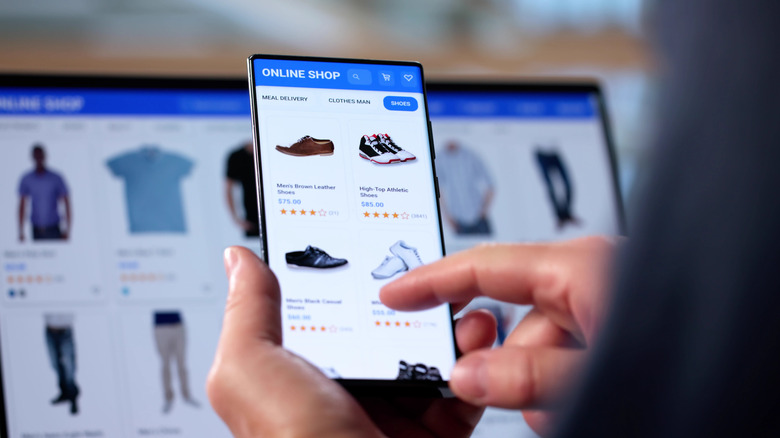 senior man texting with one finger to make purchase online