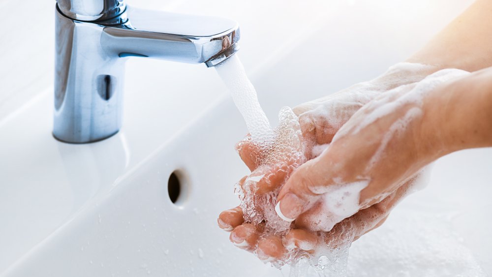 Woman use soap and washing hands under the water