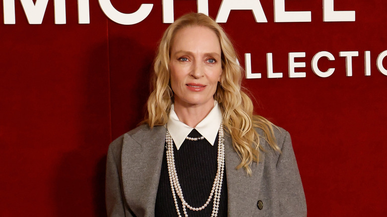 Uma Thurman smiling on the red carpet at a celebrity event