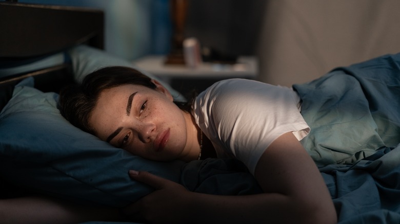 Woman lying awake in bed