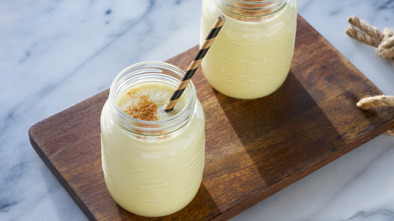 mugs of eggnog on table