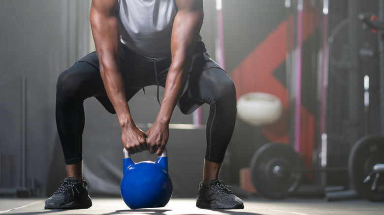 A man uses a kettlebell