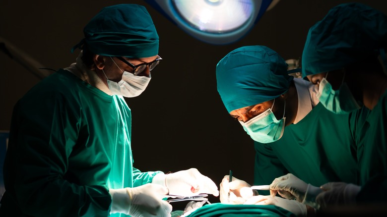 Doctors and team performing heart surgery