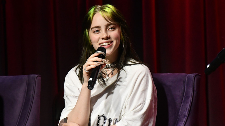 Billie Eilish speaking into a mic