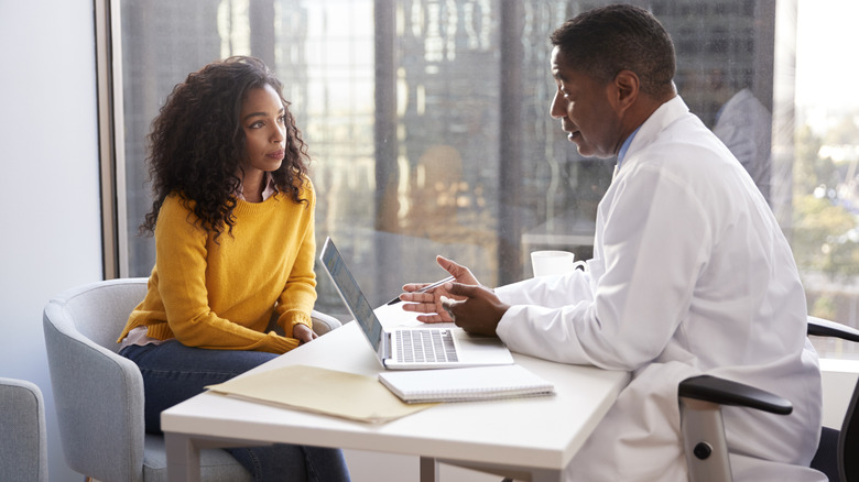 male doctor counseling with female patient