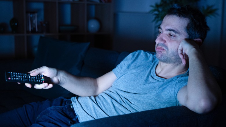 Tired man watching television 