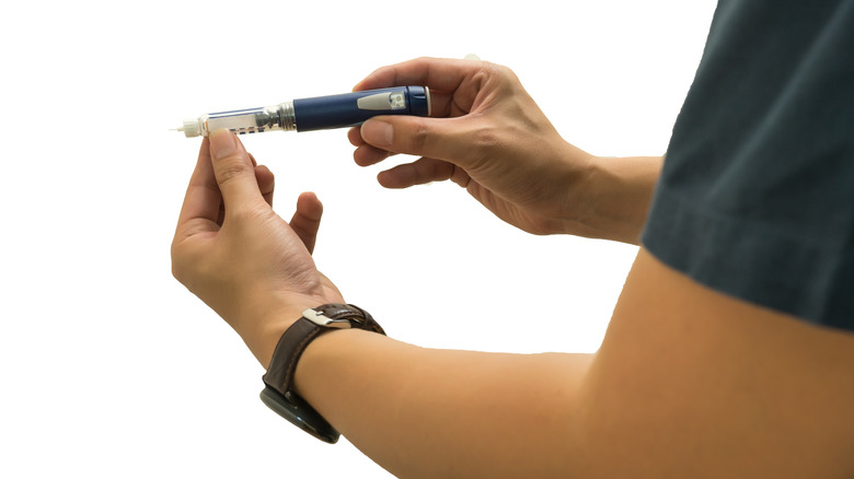 hands holding A1C test