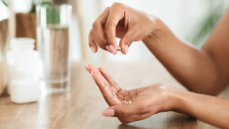 woman holding supplements