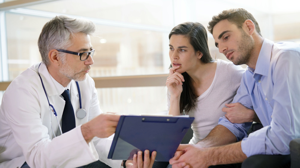 Couple talking to doctor