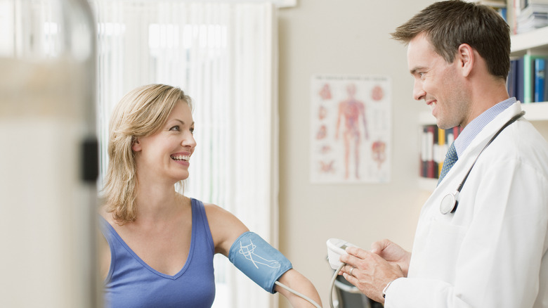 Woman getting blood pressure checked