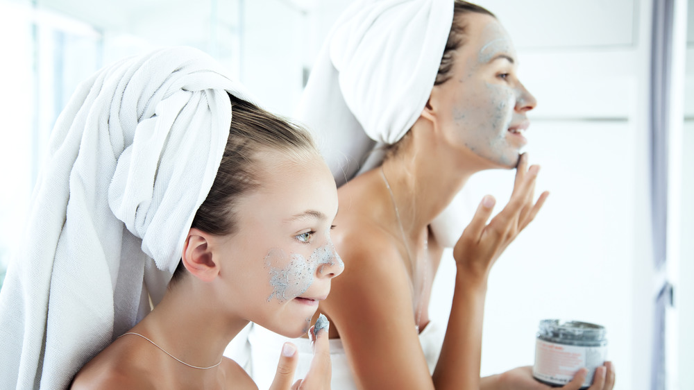 Mother and daughter doing face masks