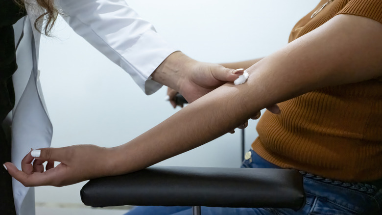 woman getting blood drawn at a clinic