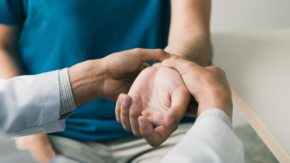 doctor examining arm