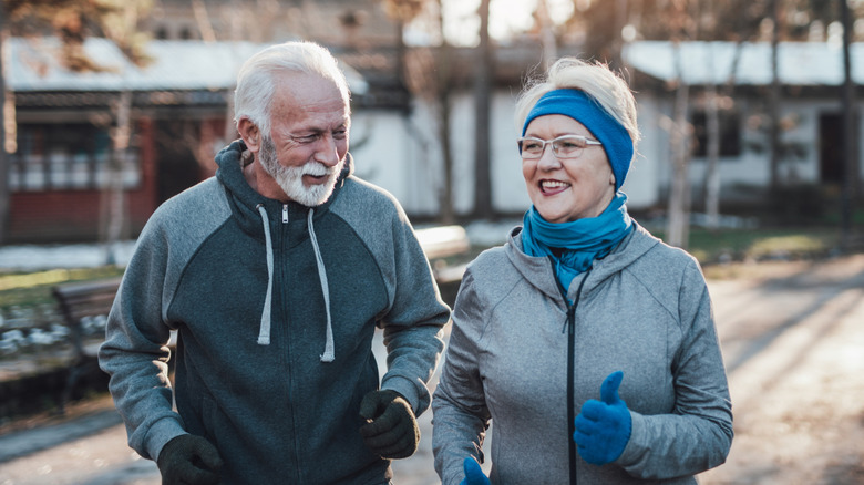 An older senior couple outside in the cold.