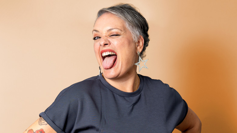 senior woman with tats sticking out her tongue