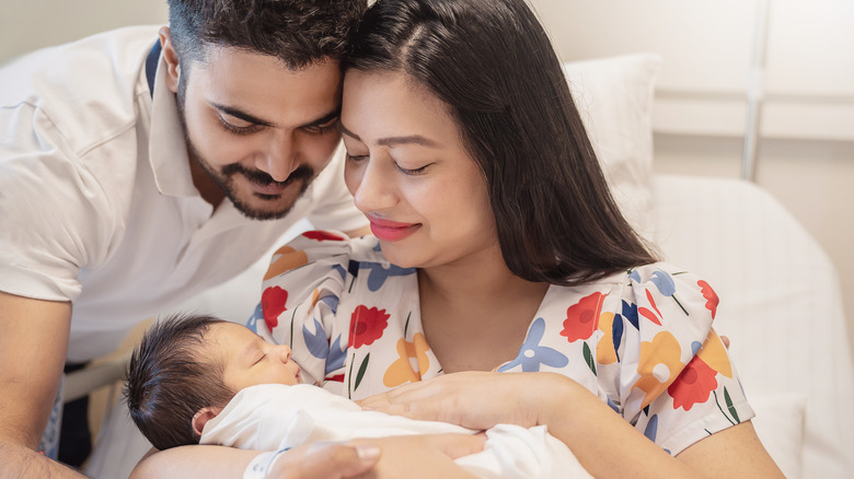 Father and mother holding their baby