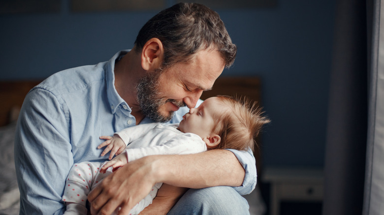 A father cradling his child