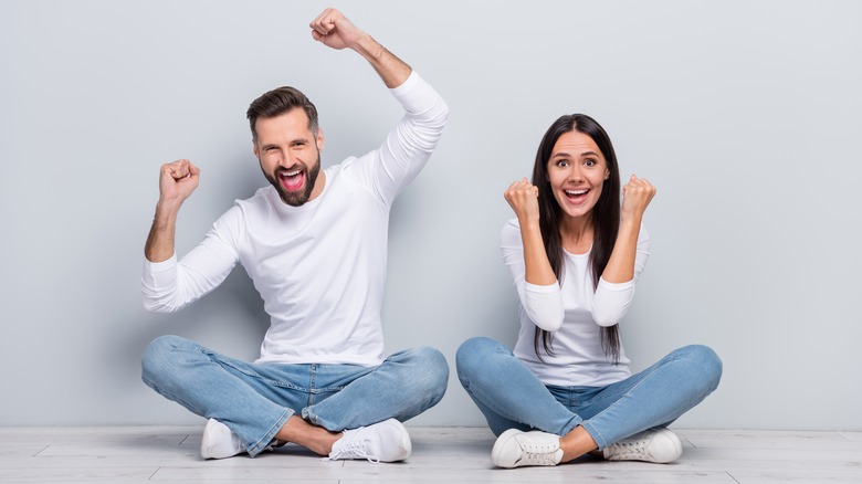 man and a woman sitting cross-legged