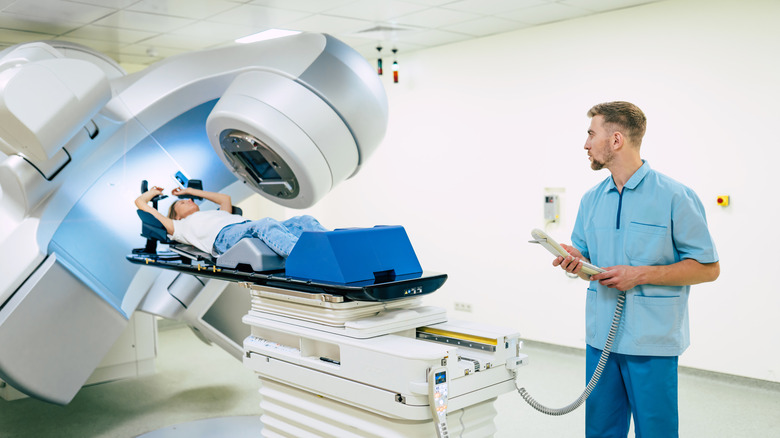 doctor performing radiation therapy