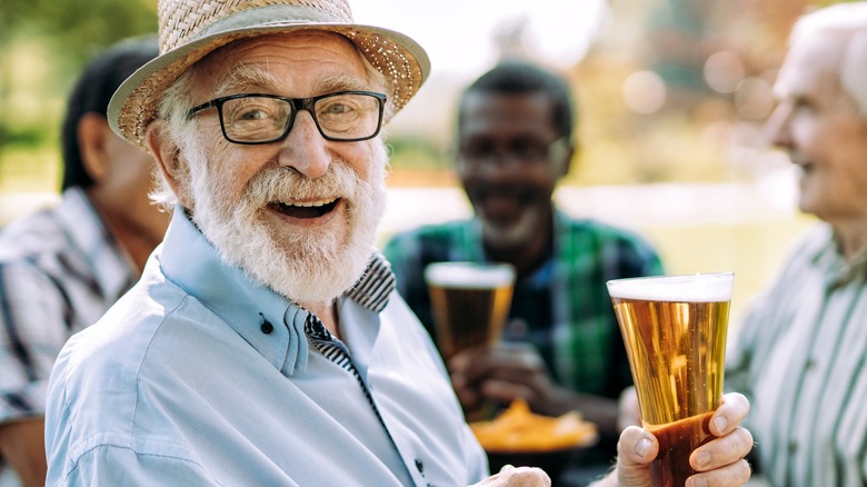 two happy men holding beer 