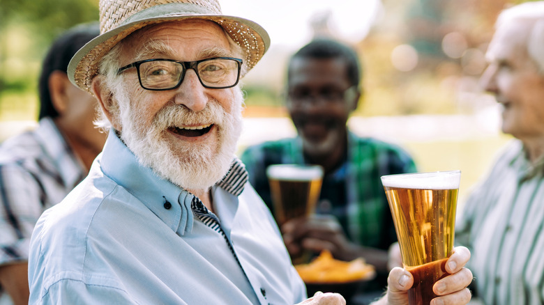 two happy men holding beer
