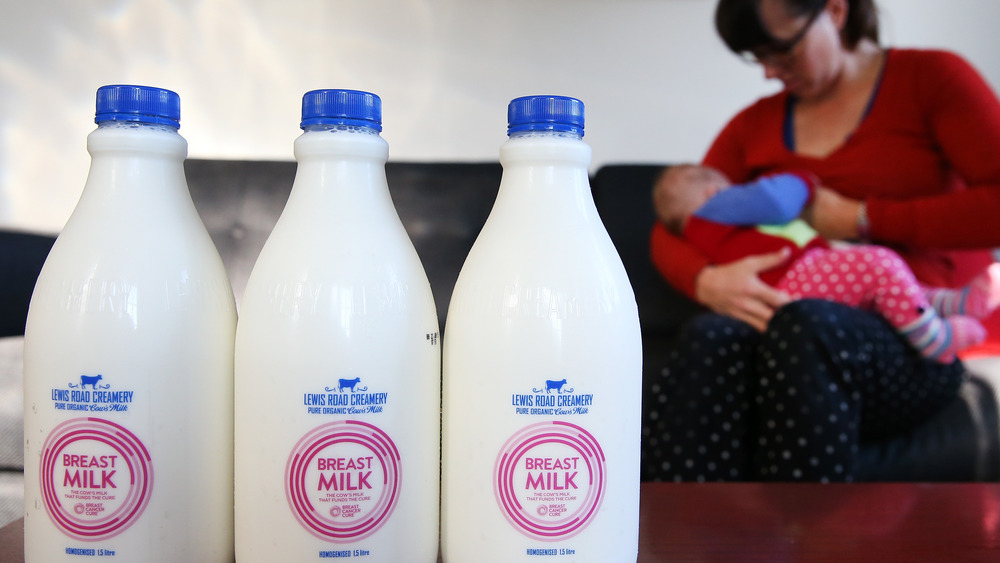 Woman breastfeeding with bottled breastmilk