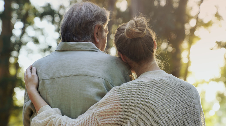 woman hugging spouse with dementia