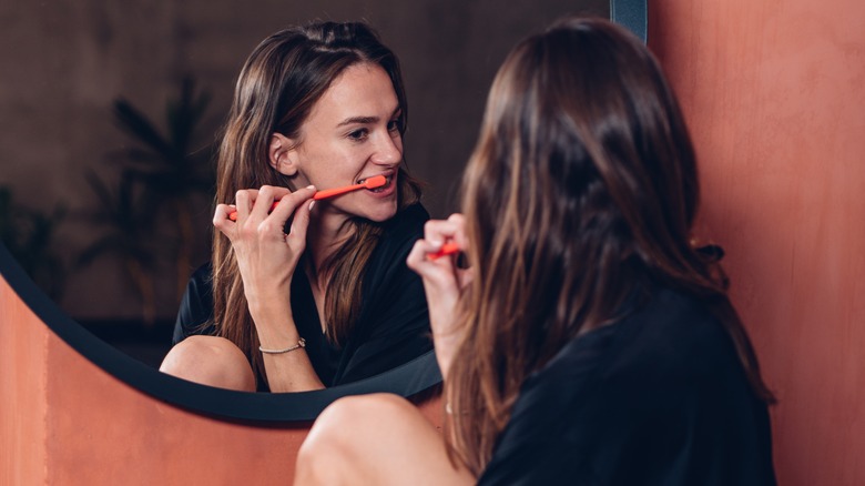 Woman brushing teeth