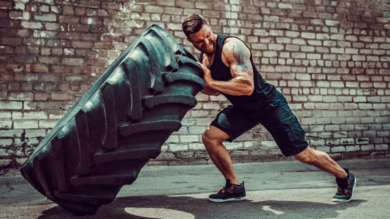 man working out with tire