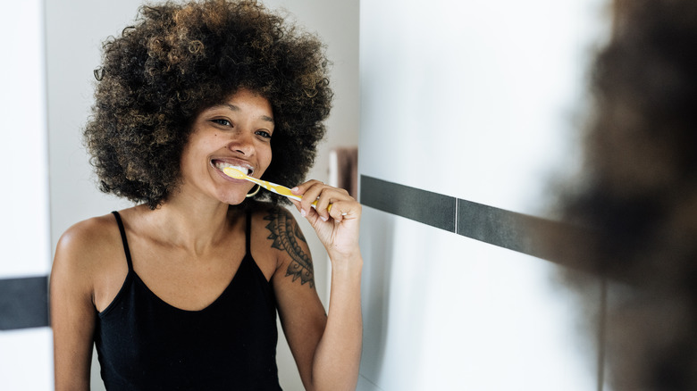 A woman brushing her teeth