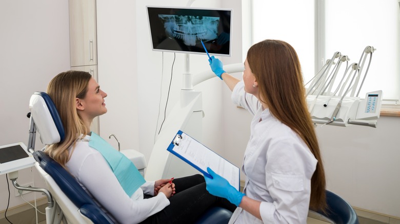A woman showing a patient x-rays