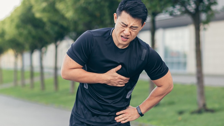 man clutching chest