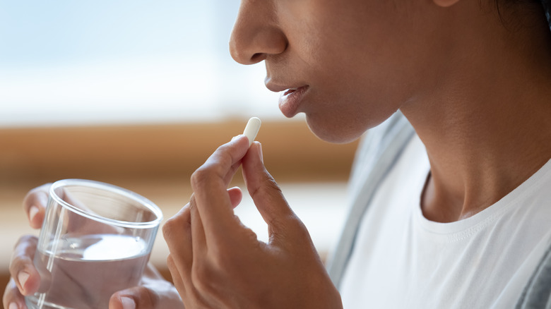 Woman taking pill