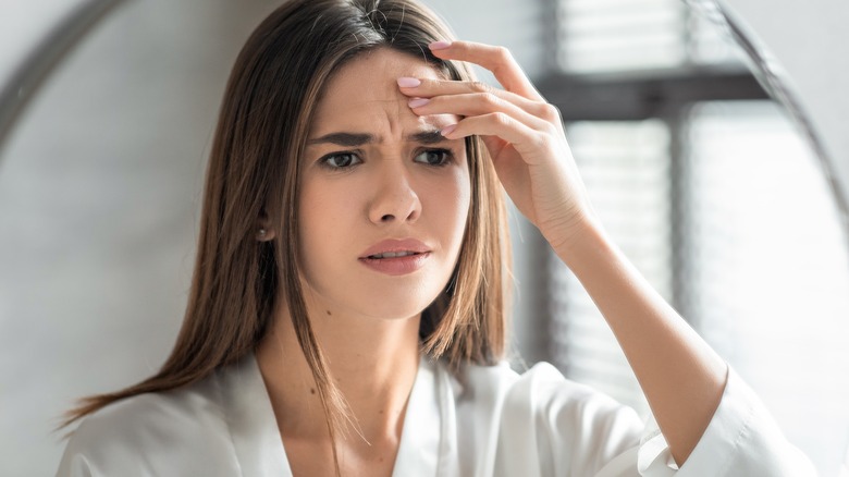 worried woman touching face