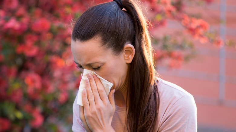 Woman blowing her nose